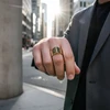Gold geometric ring on man's hand.
