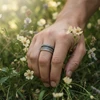 Hand model wearing ornate silver ring.