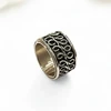 Silver ring with ornate band.