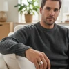 Man's hand wearing silver statement ring.