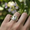 Silver statement ring with textured band and metallic spheres.