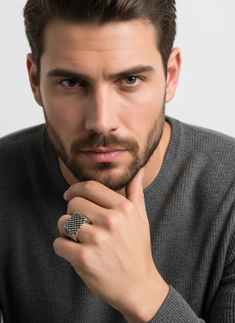 Men's textured silver signet ring.