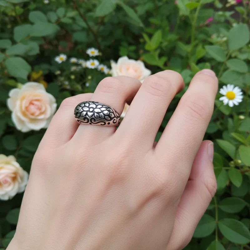 Silver ring with floral etched design.