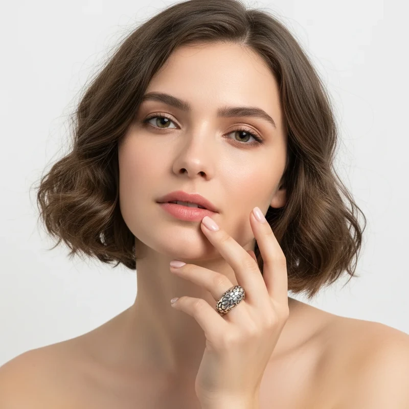 Woman's hand showcasing textured silver ring.