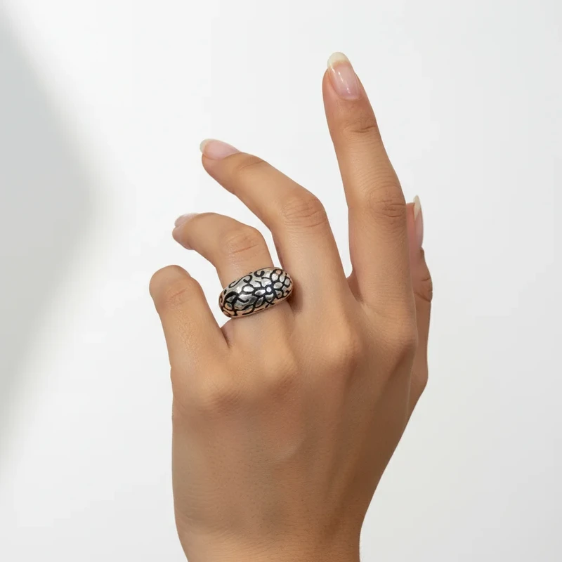 Silver ring with floral etched design.