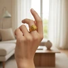 AI-Variation-home Gold textured dome ring on hand.