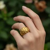 AI-Variation-nature Gold textured dome ring on hand.