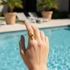 Gold filigree ring with blue gemstone.