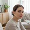 Woman wearing gold and silver hoop earrings.