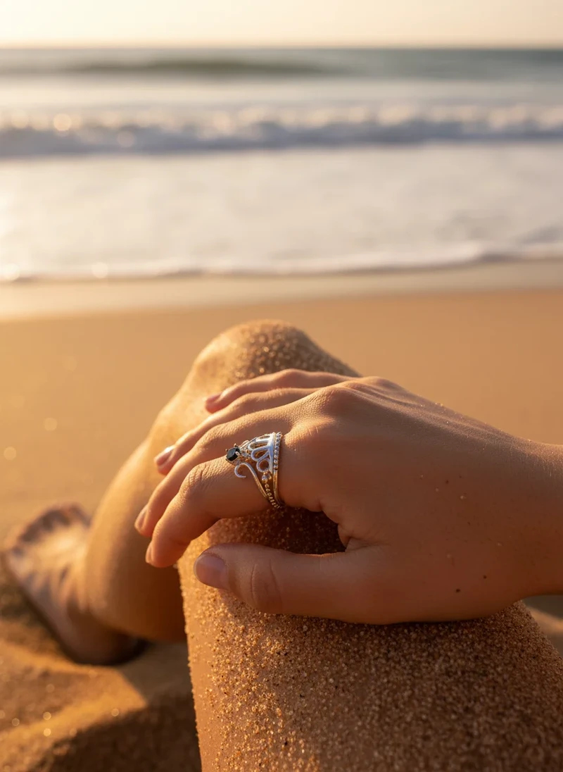 Sterling silver crown ring with black gemstone.