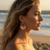 Silver ornate half-moon earrings.