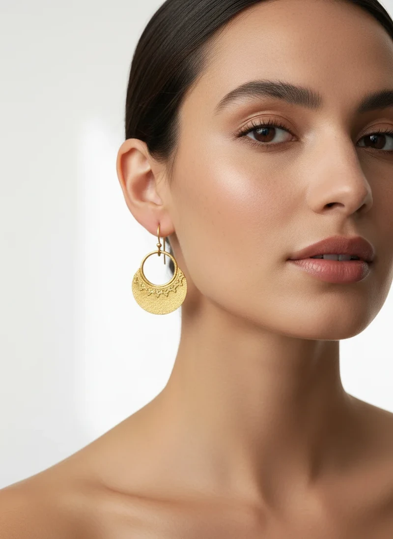 Gold textured half-circle drop earrings.