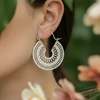 Silver filigree hoop earrings.