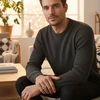 Man wearing gray sweater and signet ring.
