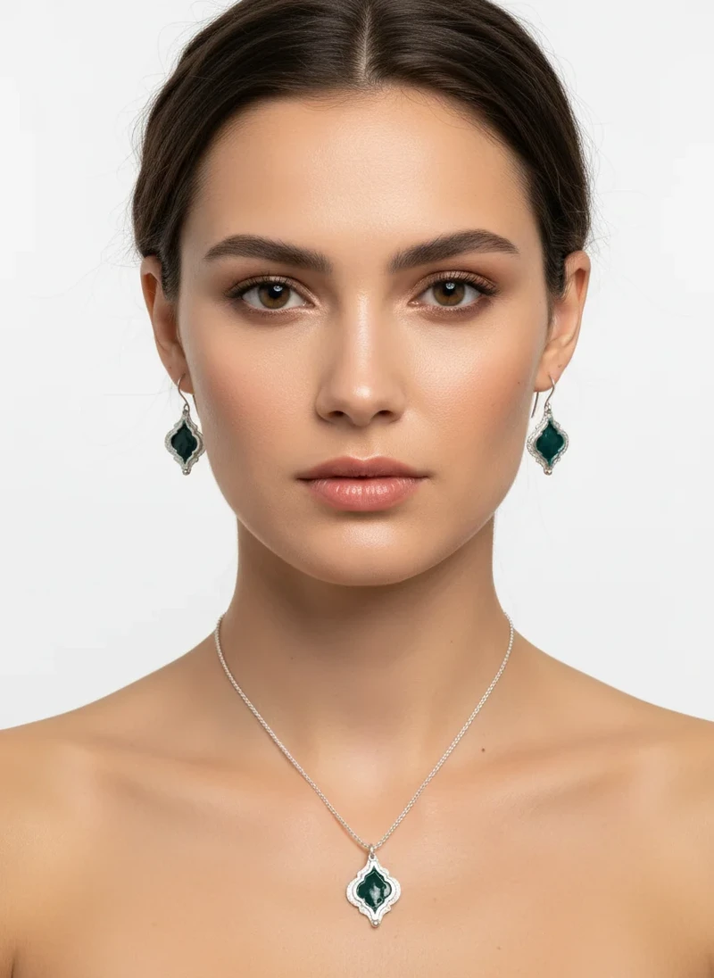Woman wearing dark green stone necklace & earrings.