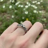 Silver floral ring on hand.