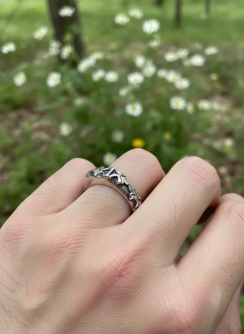 Silver floral ring on hand.