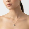 Silver necklace with dark blue gemstone pendant.