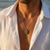 Silver Hamsa necklace with black detailing.