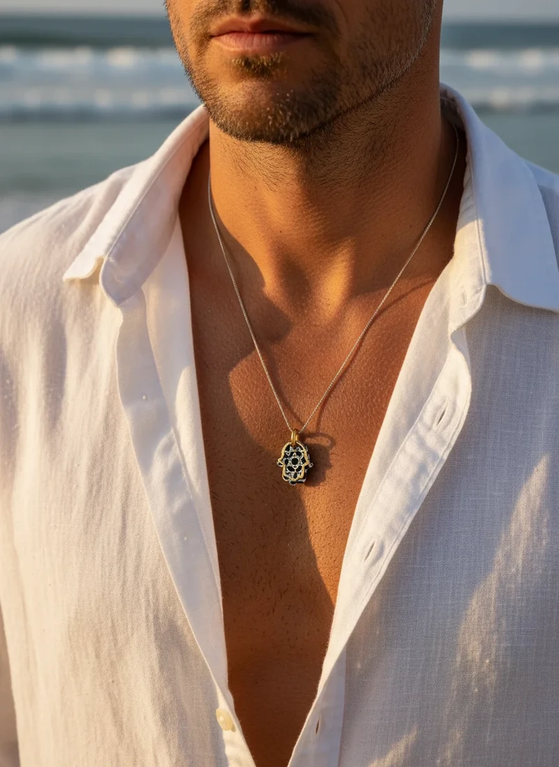 Silver Hamsa necklace with black detailing.