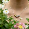 Silver necklace with three textured gold and silver beads.