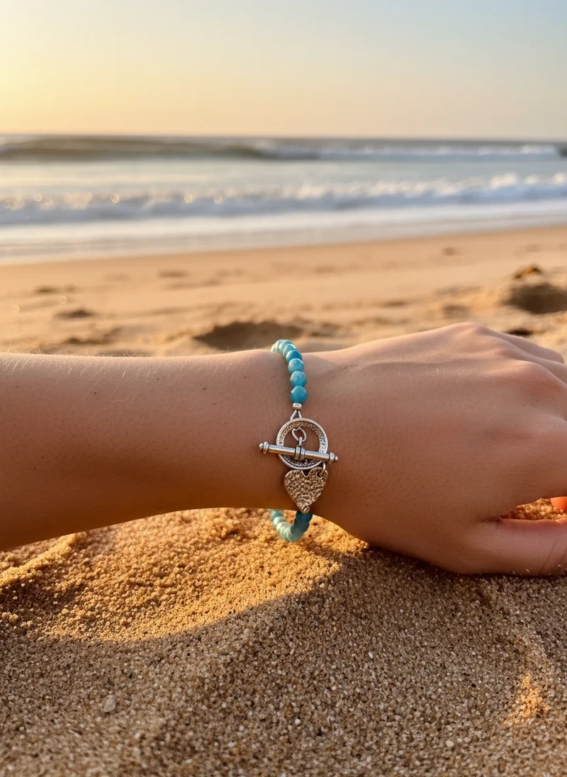 Beaded turquoise bracelet with silver heart charm.