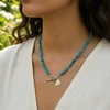 Teal gemstone beaded necklace with silver heart charm.