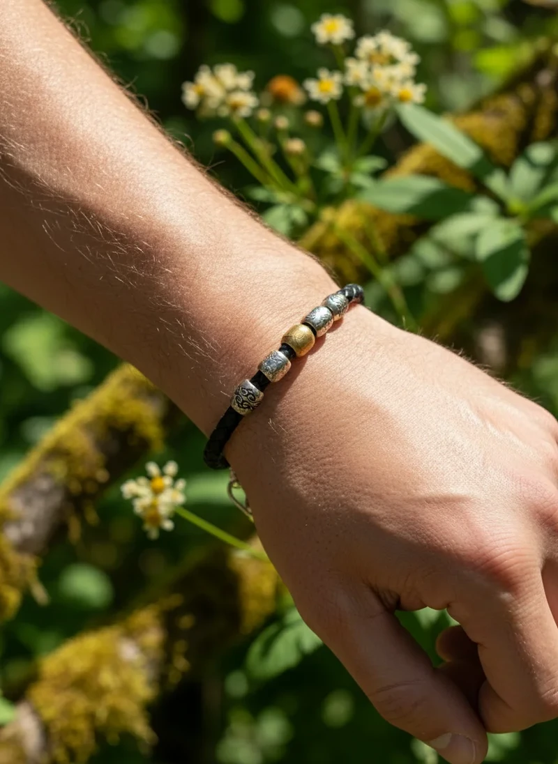 Men's beaded leather bracelet with silver and gold accents.