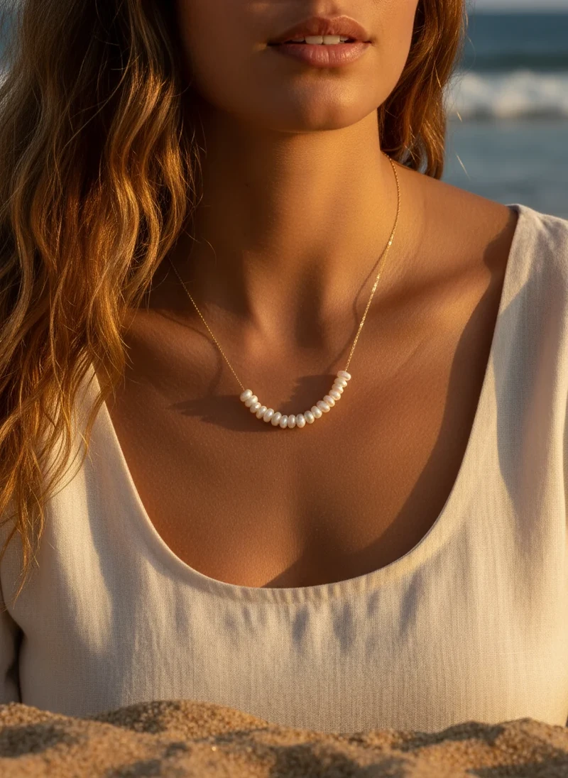 Gold chain pearl necklace.