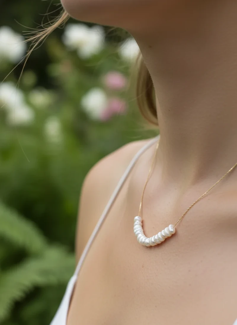 Delicate gold pearl necklace.