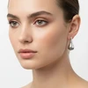 Woman wearing silver teardrop earrings.