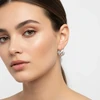 Silver cutout hoop earrings.