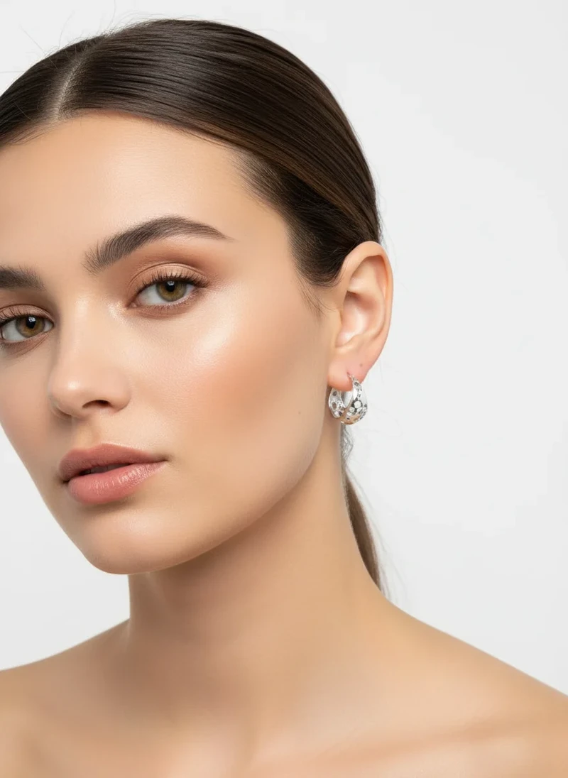 Silver cutout hoop earrings.