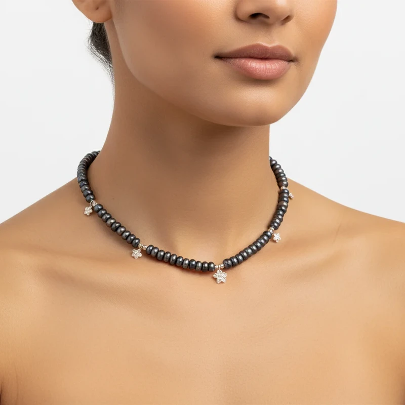 Black pearl choker necklace with floral accents.